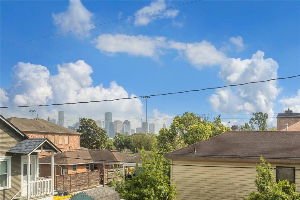 Take in striking skyline views from the upstairs balcony, offering a rare vantage point that blends peaceful backyard scenery with the dynamic Houston cityscape.