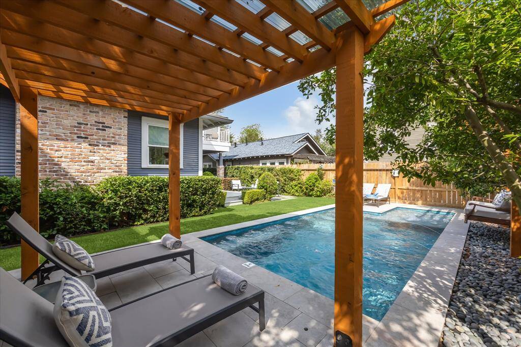 Enjoy peaceful afternoons by the pool under the pergola, complete with lounge chairs and privacy landscaping. The perfect balance of shade and serenity.