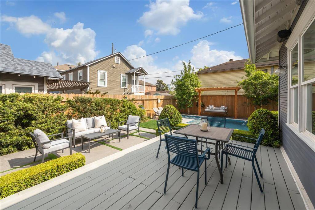 This elevated dining deck just off the kitchen provides seamless indoor-outdoor flow and overlooks the pool and lounge area, ideal for al fresco meals and gatherings.