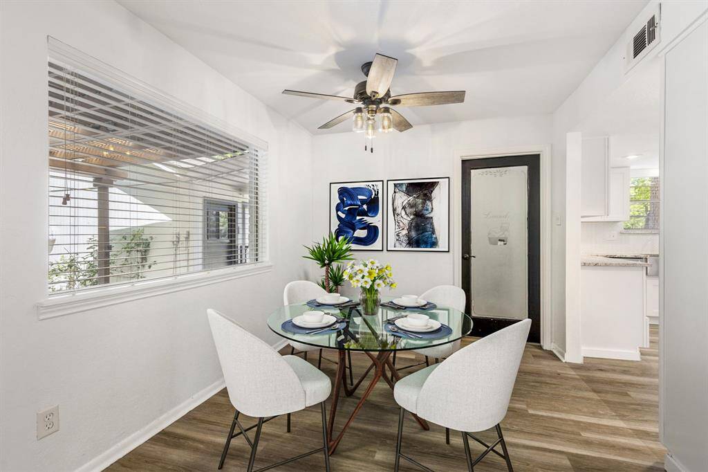 The breakfast nook is located off of the kitchen, next to the utility room, and is open to the living room.