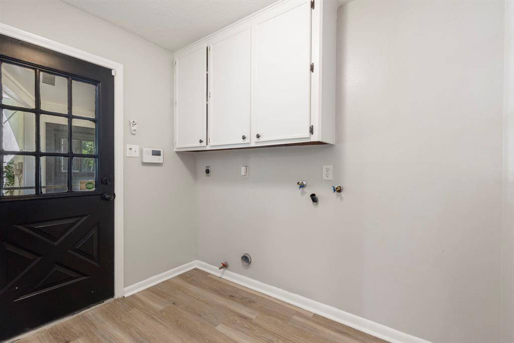 The utility room is located on the first floor and has an access door leading to the breezeway.