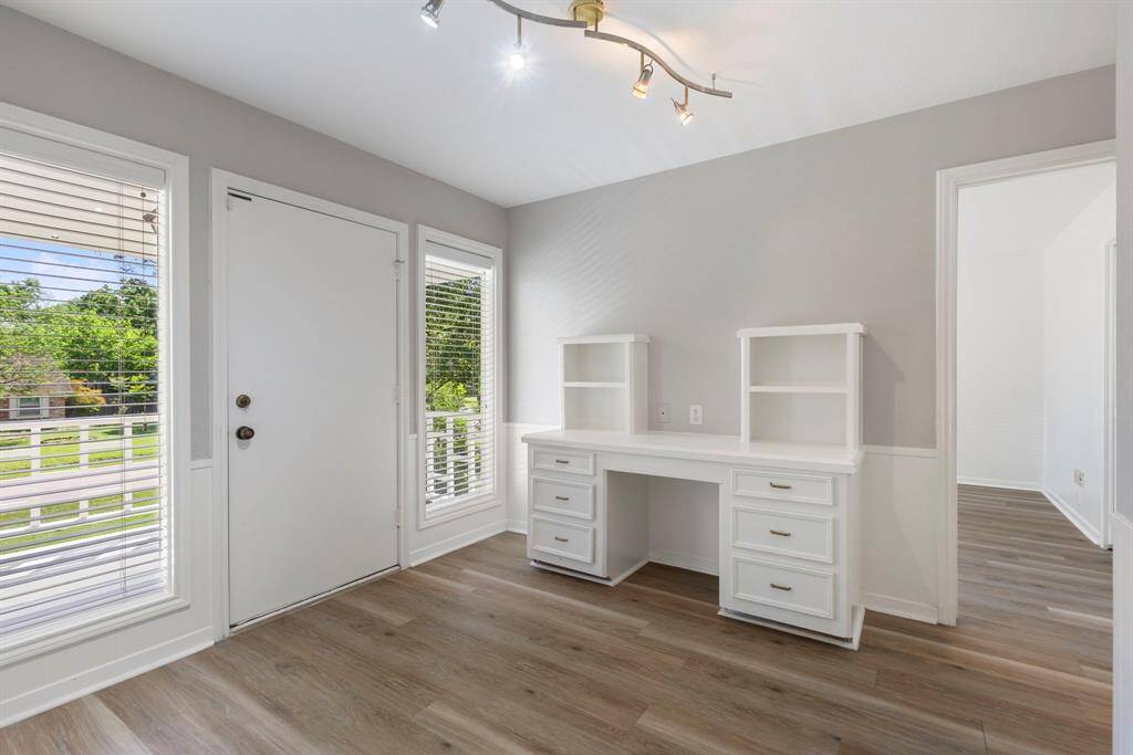 The upstairs landing features a built-in desk and access to the balcony.