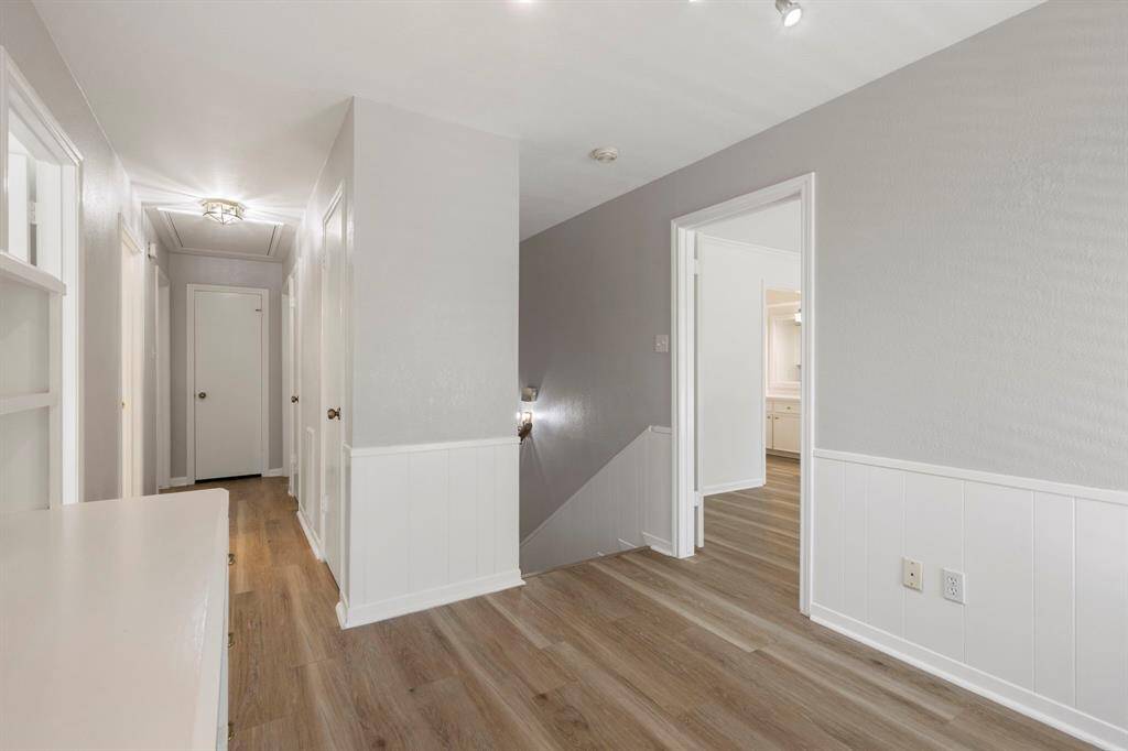 The upstairs landing features a built-in desk and access to the balcony.