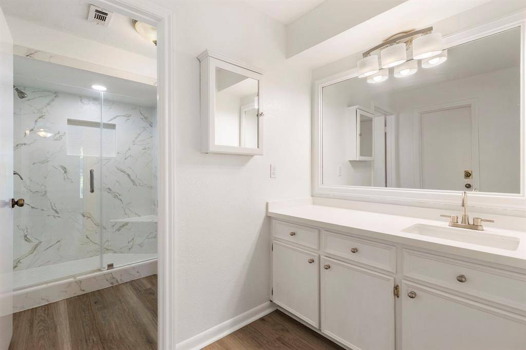 The primary bathroom includes fabulous updates like countertops, light fixtures, a completely renovated shower and more!