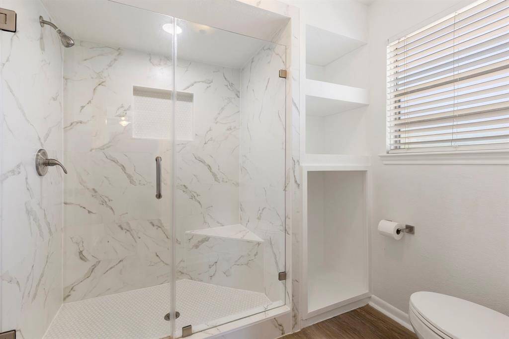 The primary bathroom includes fabulous updates like countertops, light fixtures, a completely renovated shower and more!