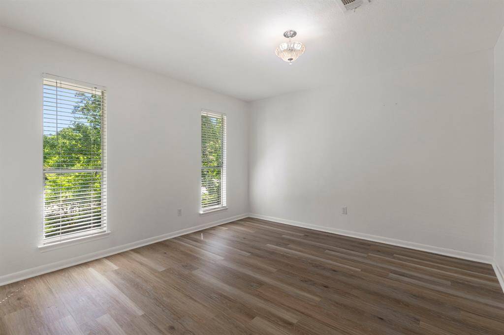 The 1st secondary bedroom is located to the right of the balcony and overlooks the from yard.