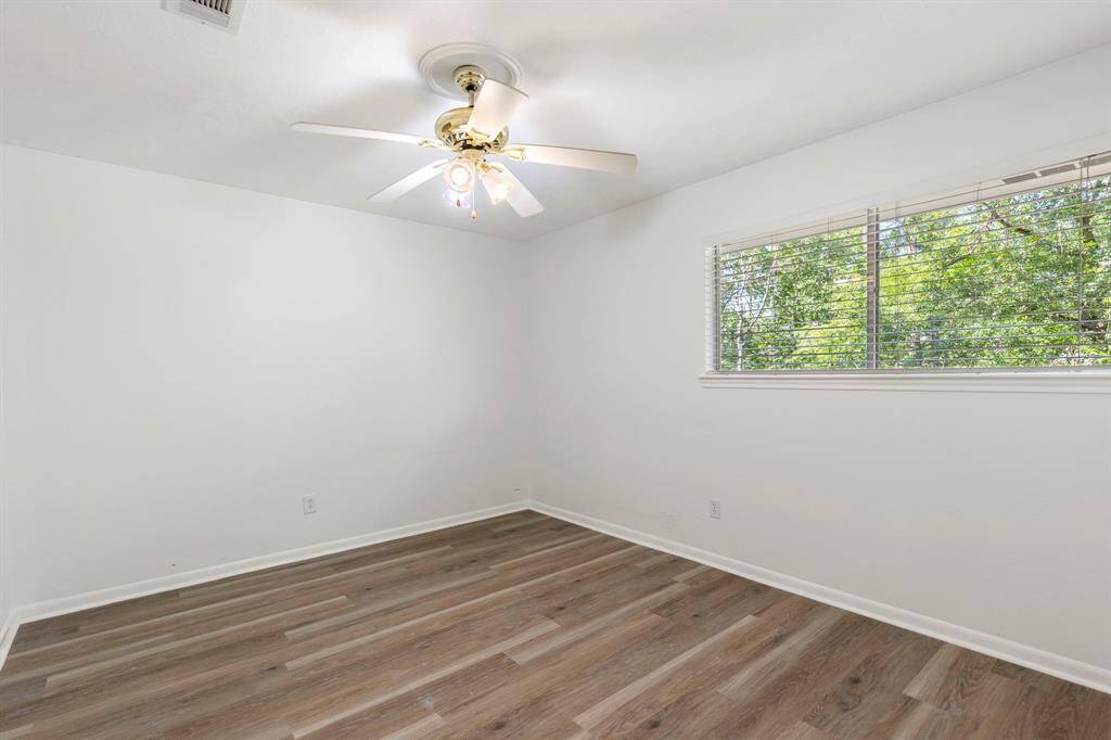 The 2nd secondary bedroom is located to the back left of the hall and overlooks the backyard.