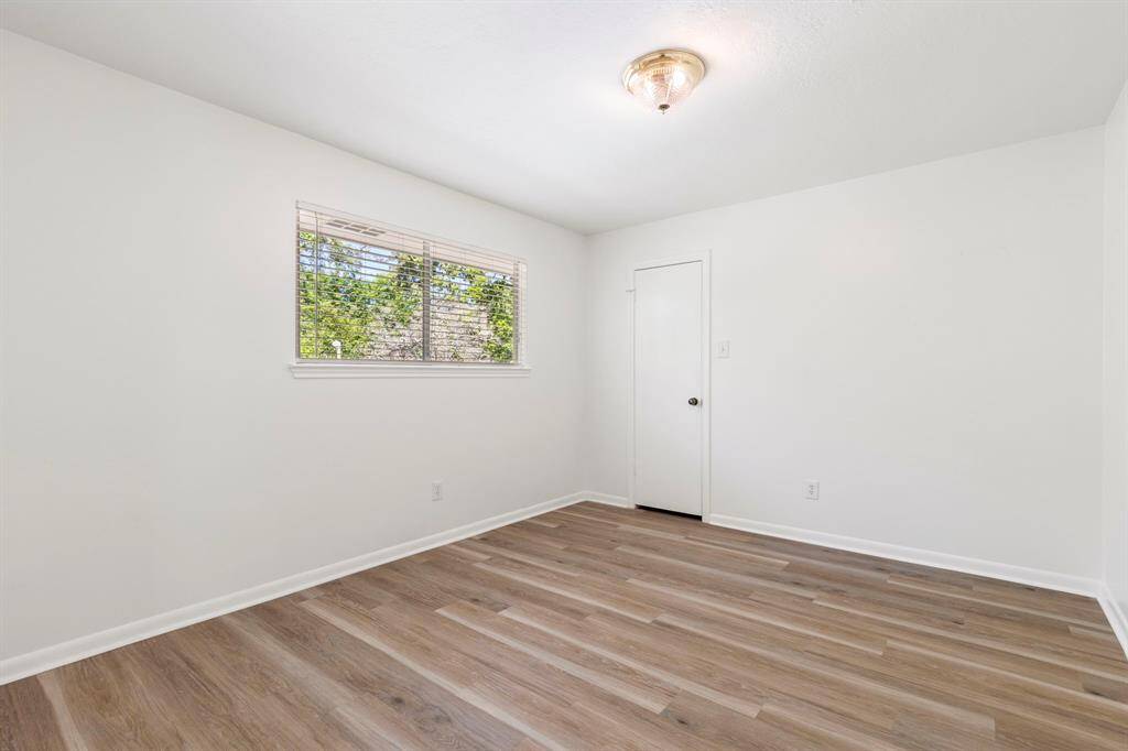 The 3rd secondary bedroom is located to the back right of the hall and overlooks the backyard as well.