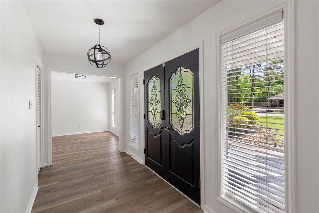 The double door entry offers an impressive entrance that leads to the dining room and formal living space.