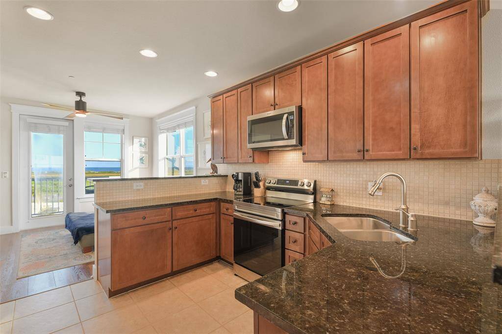 Rich maple cabinets line the kitchen, complemented by granite counter tops.