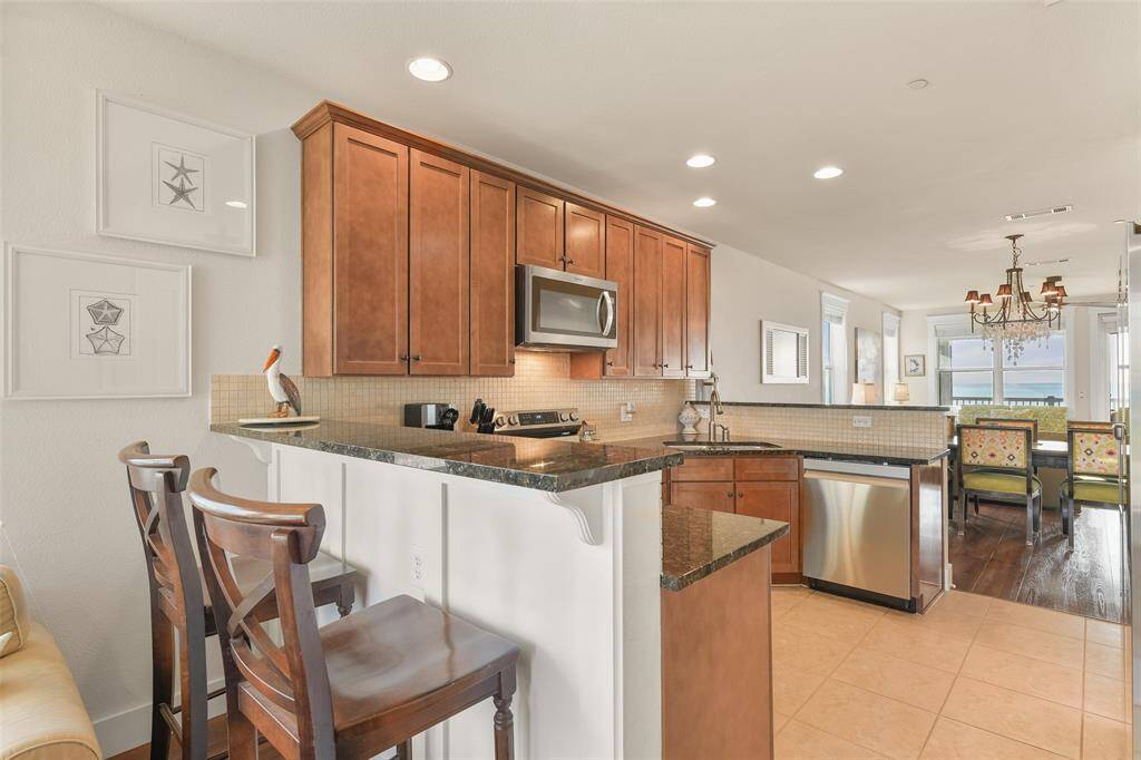 The is the South side of the kitchen, showing the secondary breakfast bar. Your guests will dine with a Bay view here.