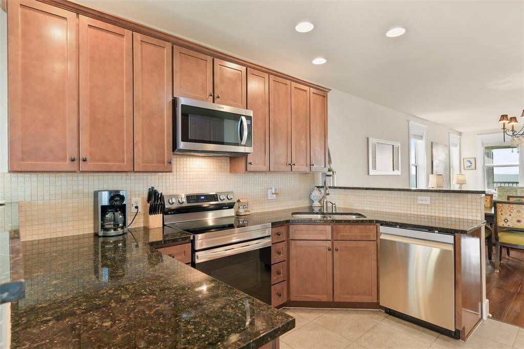 The suite of stainless Samsung appliances were recently installed. Look at all of the counter space for meal prep.