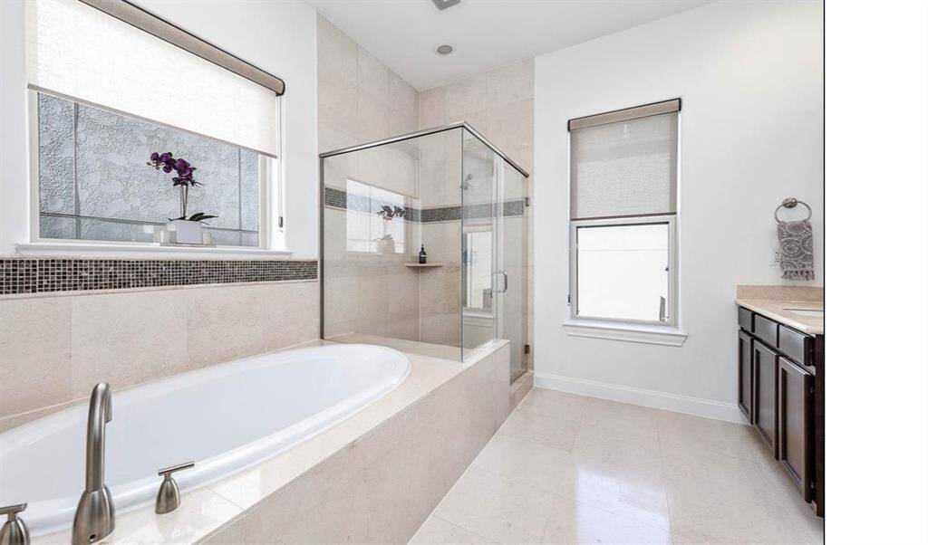 Enjoy the best of both worlds in the primary bathroom – a spacious soaking tub and a luxurious walk-in shower for ultimate relaxation.