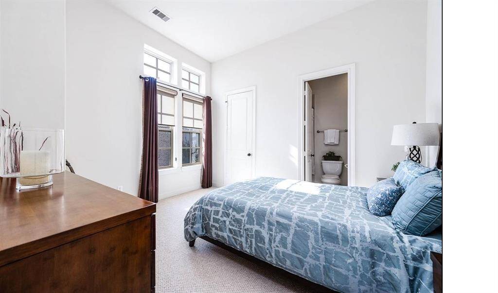 Secondary bedroom with jack and jill bathroom. Windows face the front of the home. Second secondary bedroom is not shown.