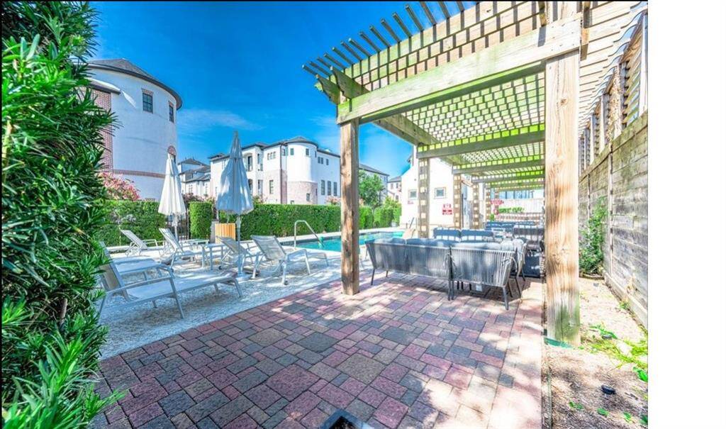 Unwind by the community pool, with comfortable benches and a inviting patio perfect for relaxation and socializing.