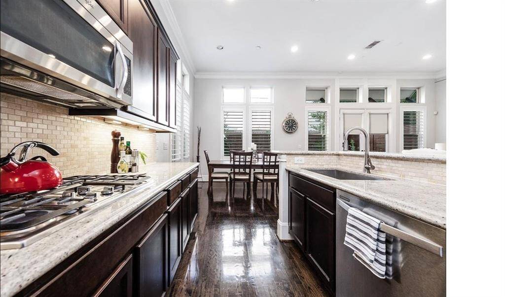 Stainless steel appliances and custom window coverings.