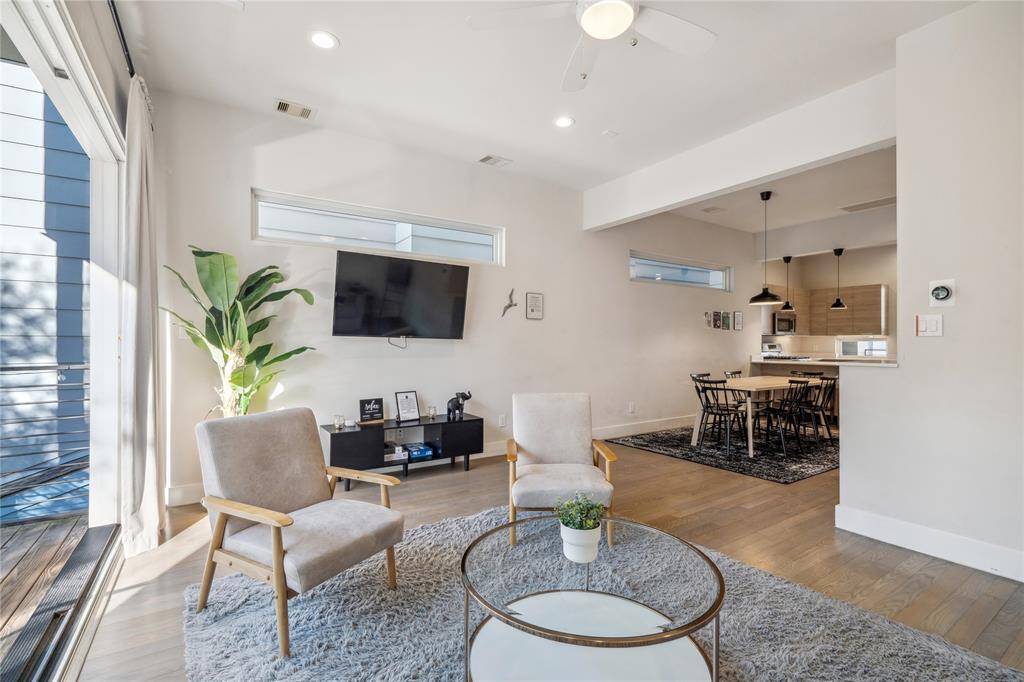 The open floor plan seamlessly connects to the dining area and kitchen, making it perfect for entertaining.