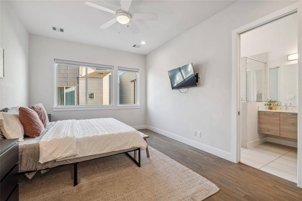 A wide entryway lead from the bedroom into the bathroom, offering an open yet intimate feel.