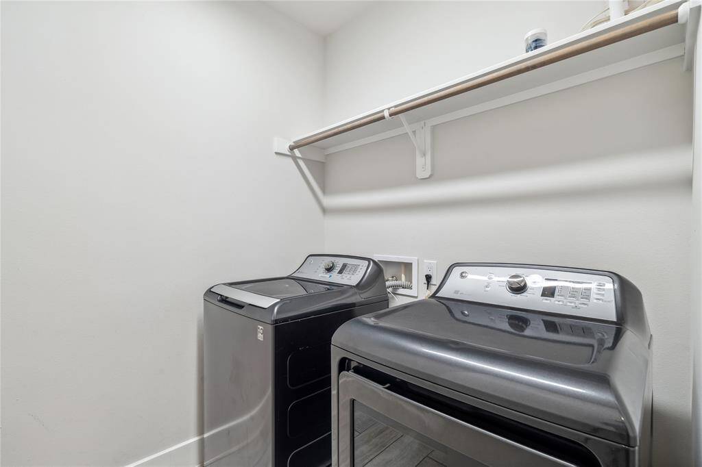 The laundry room is designed for efficiency and convenience, featuring ample space for a full-sized washer and dryer. Thoughtfully placed within the home, it offers easy access while keeping laundry chores tucked away.