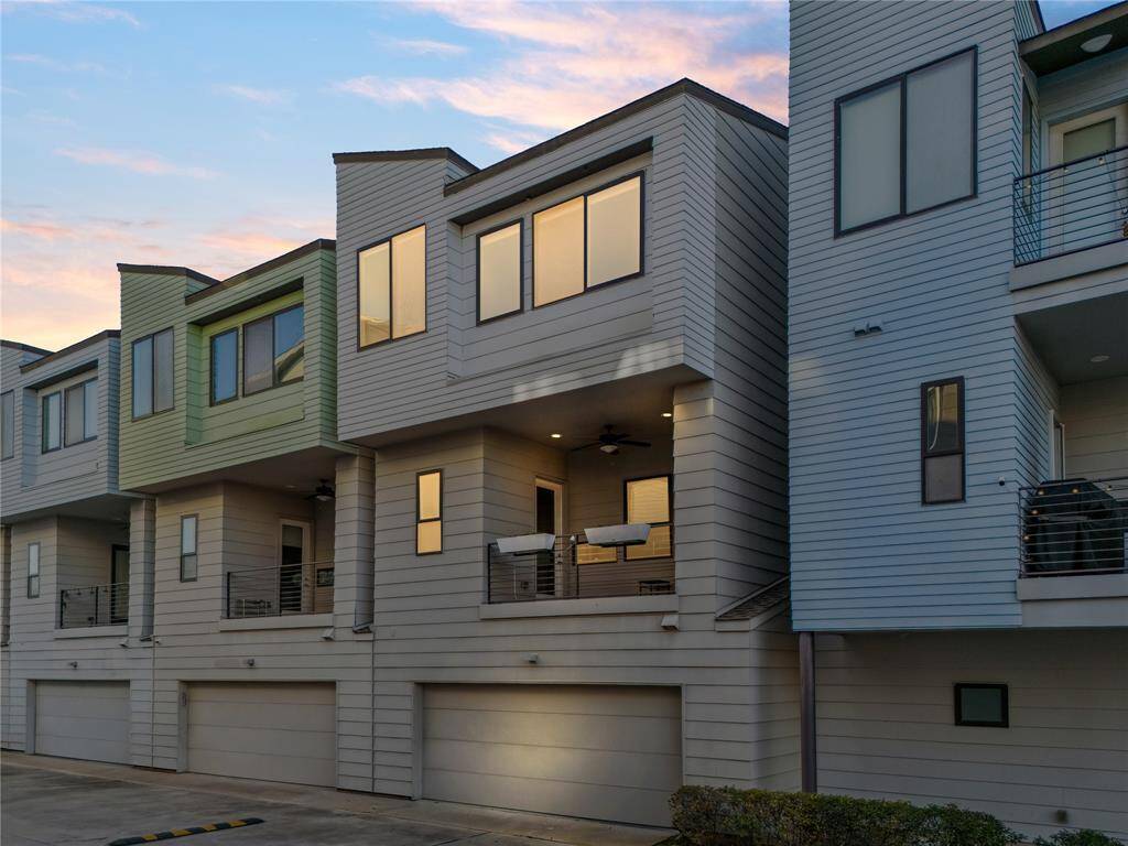 The exterior lighting highlights the sleek architectural lines, illuminating the contemporary facade with soft, ambient tones.