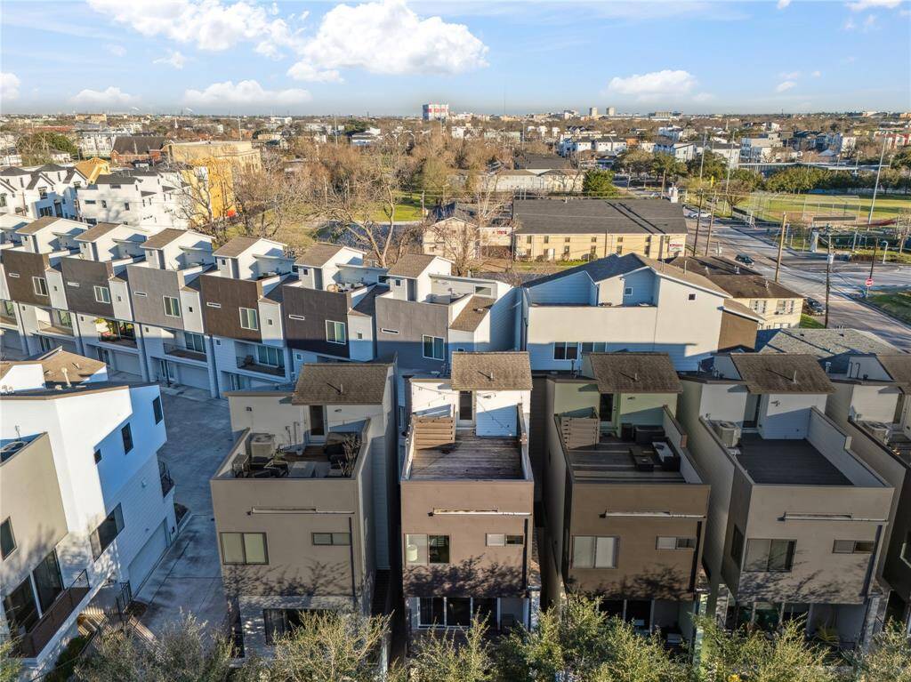 Nestled in a vibrant townhome community, the property is part of a well-planned development with uniform yet stylish facades, featuring a mix of neutral and accent colors that create a cohesive streetscape.