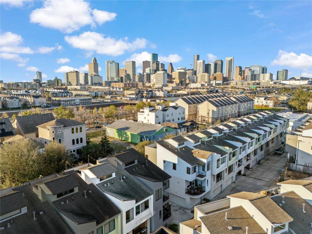 Beyond the home, the downtown skyline rises in the distance, offering breathtaking views of Houston’s iconic high-rises, bustling streets, and city lights.