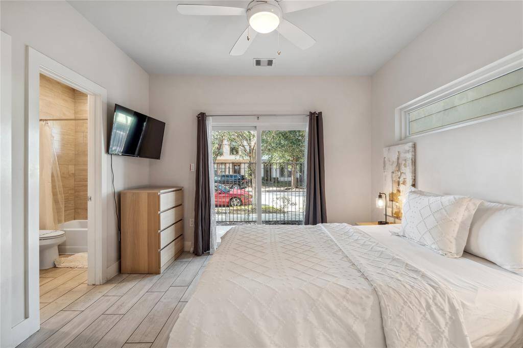 This spacious first-floor secondary bedroom offers both privacy and versatility, making it an ideal space for guests, a home office, or even a workout room.