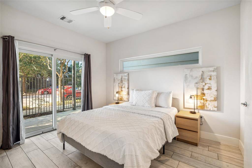 Large windows invite natural light, while neutral-toned walls and sleek flooring provide a modern and inviting atmosphere.