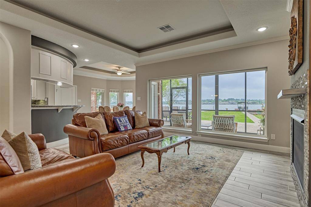 Another view of the living room with kitchen, breakfast area and screened in porch beyond.