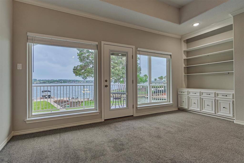 A closer look at the second-floor balcony reveals a serene vantage point with sweeping views of the lake—an ideal spot to relax and take in the natural beauty.