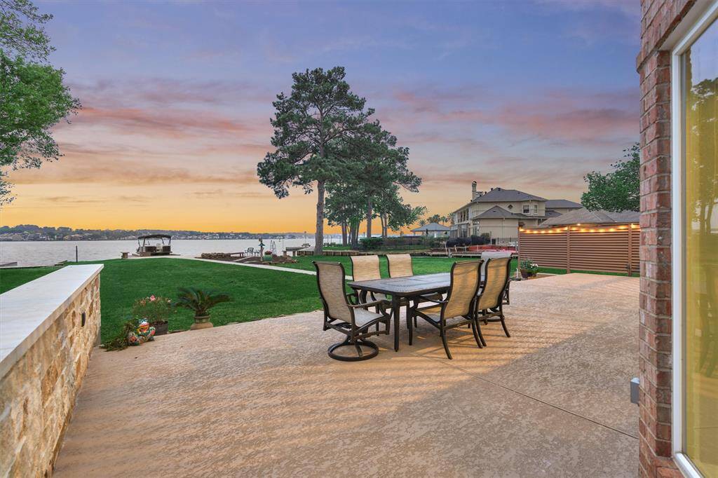 The back patio was recently constructed with cool decking, making it a comfortable retreat for summer enjoyment. This thoughtful feature extends down the sidewalk, leading all the way to the boat dock for a seamless and stylish outdoor experience.