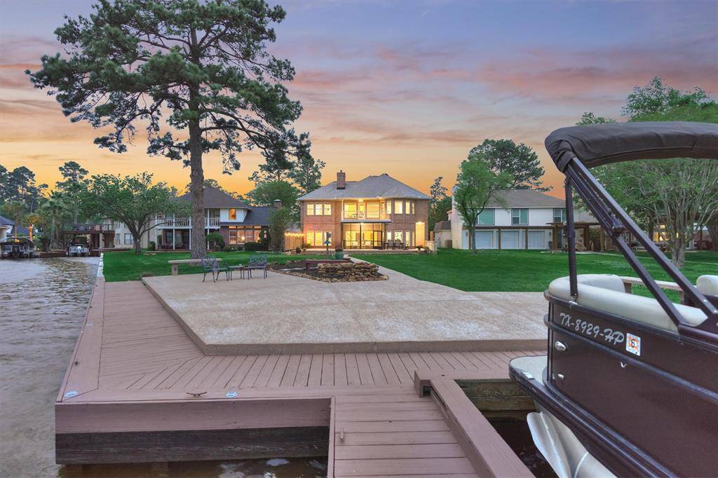 A look back at the house at night reveals its stunning illumination, showcasing the home's elegant design and its welcoming ambiance coming in from the lake.