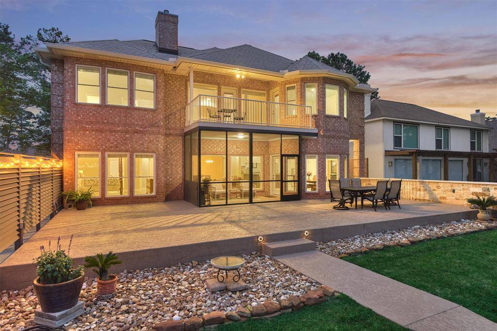 The expansive patio area is bordered by attractive rock landscaping and offers ample space for multiple seating arrangements, making it perfect for entertaining or simply relaxing outdoors. New gutters were recently installed around the home.