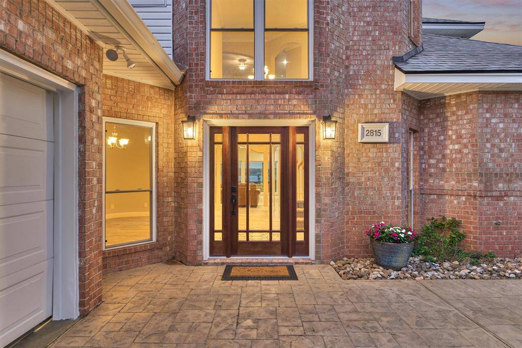 Enter through a beautifully updated wood and glass door that sets the tone for the stylish interior within.