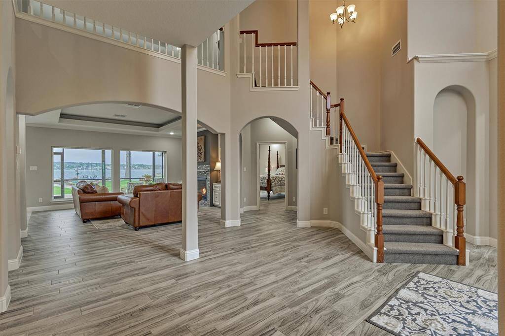 Step into the stunning two-story entryway and be instantly greeted by breathtaking views of Lake Conroe stretching out beyond.