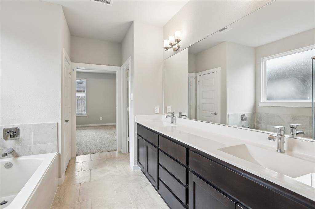 Master bathroom with tub and shower