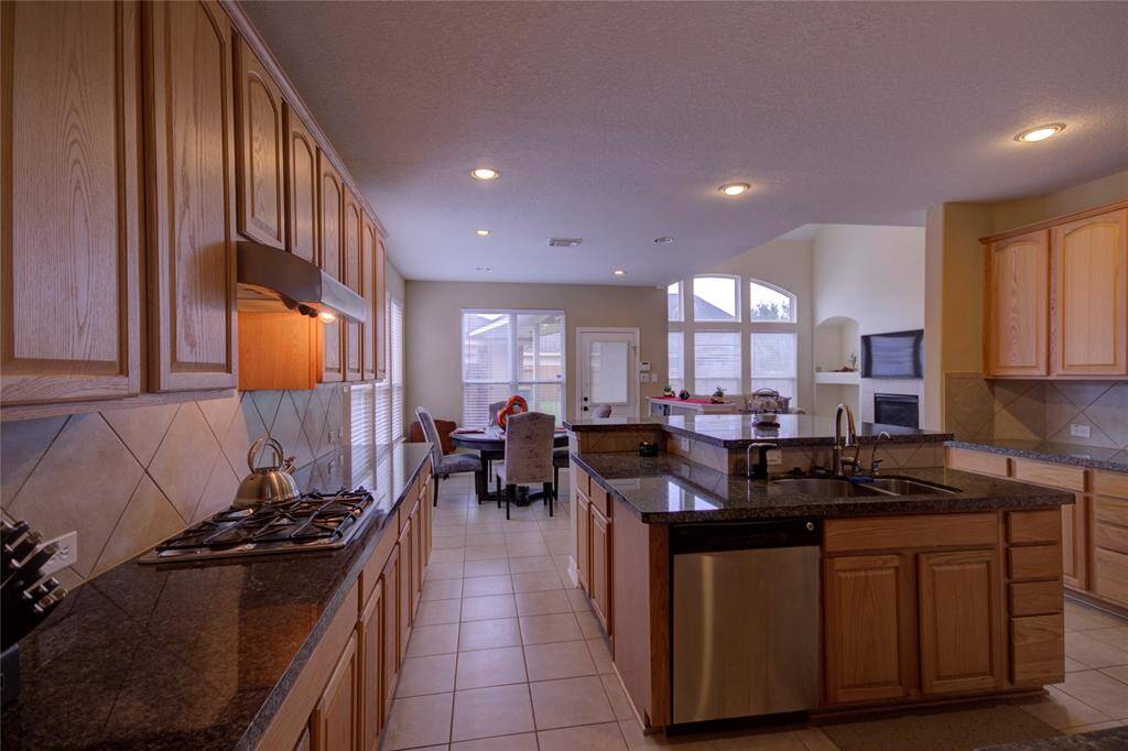 Spacious Kitchen with Stainless Steel Appliances, Ample Counterspace, Cabinets & Island