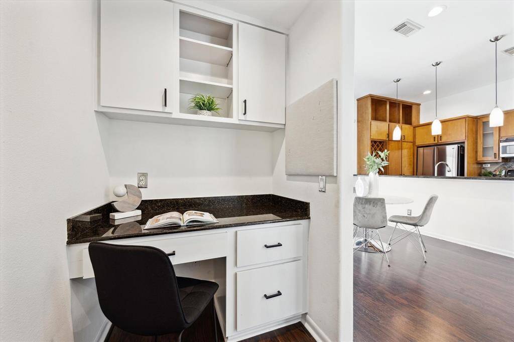 Tucked away on the main floor, this convenient nook has been transformed into a private study complete with custom cabinetry and a built-in desk, an ideal space for the at-home professional or household manager.