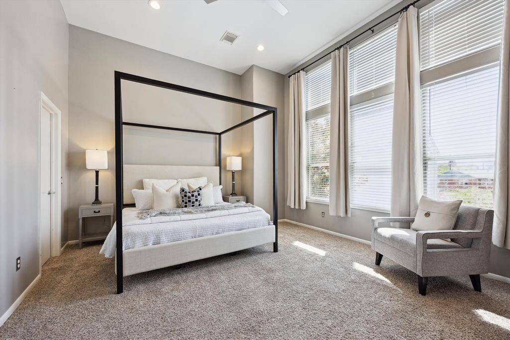 This posh retreat promises sweet dreams every night, featuring soft neutral finishes, soaring ceilings, and stacked windows that flood the space with natural light. A thoughtfully designed custom closet enhances everyday convenience, while the spa-inspired ensuite bath elevates the space into a true sanctuary.