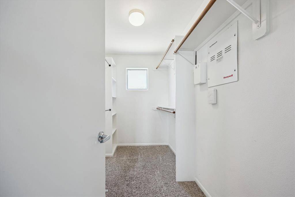 Shop until you drop! This deep walk-in closet has plenty of space for handing clothes, bags, shoes and more.