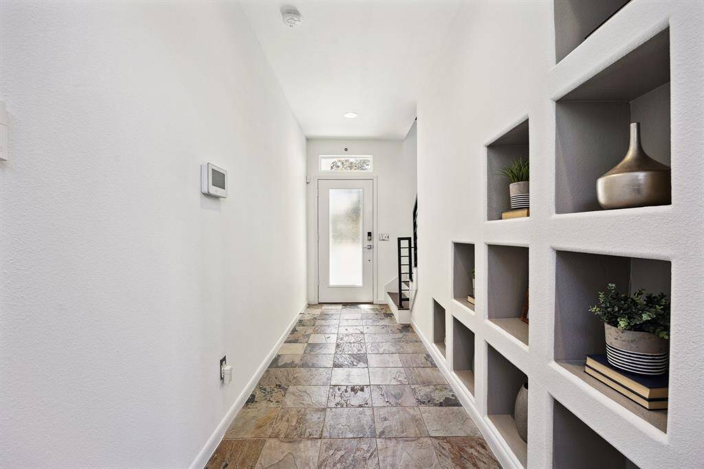 The ground floor sets the tone with sleek slate tile flooring, neutral paint tones, and clean architectural lines creating a stylish backdrop to showcase your favorite art or statement pieces.