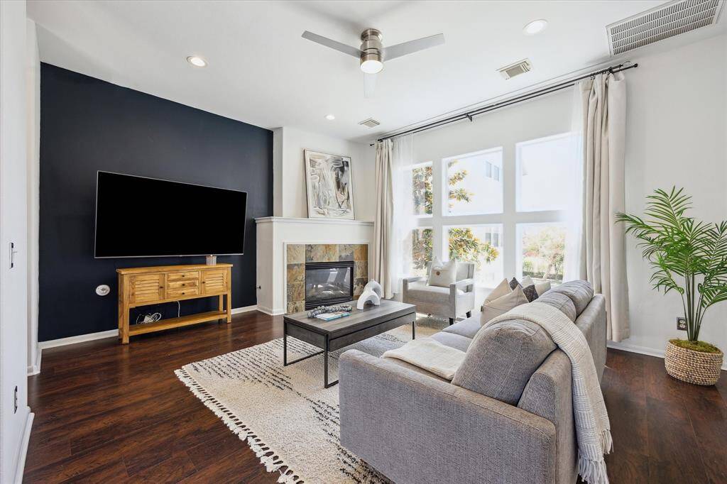 The family room offers a wonderful setting to relax and unwind or entertain friends and family. This inviting space features luxury vinyl plank flooring, neutral/designer paint, stacked windows that flood the room with natural light, and a romantic gas-log fireplace for cozy evenings in.