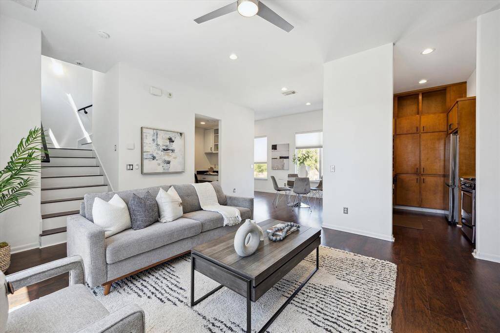 Designed with connection in mind, the family room opens effortlessly to both the dining area and kitchen, allowing guests to mingle with ease and conversations to flow freely.
