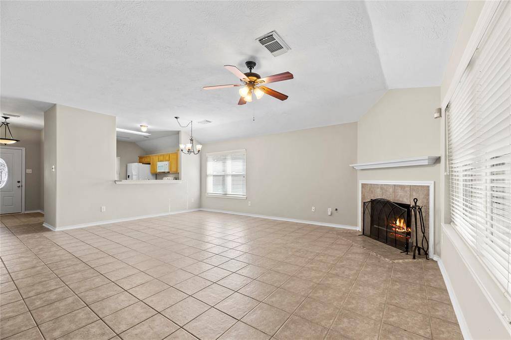 The large living area, adjacent to the kitchen and dining area, offers a comfortable and inviting space for relaxation and socializing.