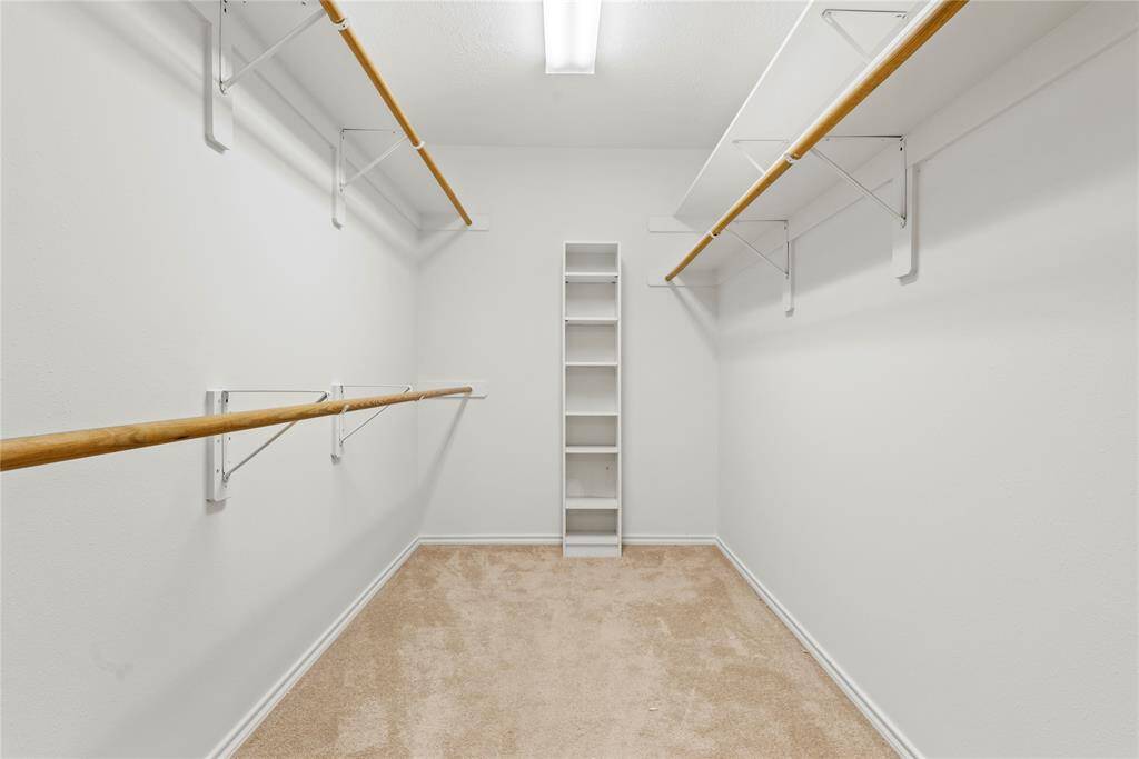 The primary closet offers ample space to store all your clothes and keep everything organized.