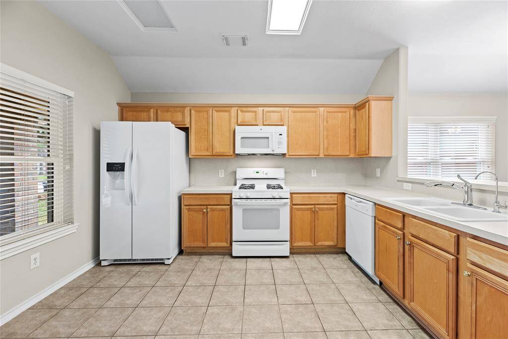 Your chef inspired kitchen awaits! Features include easy care countertops, high end appliances, rich cabinets with updated hardware, tons of lighting, and a sprawling island with breakfast bar seating.
