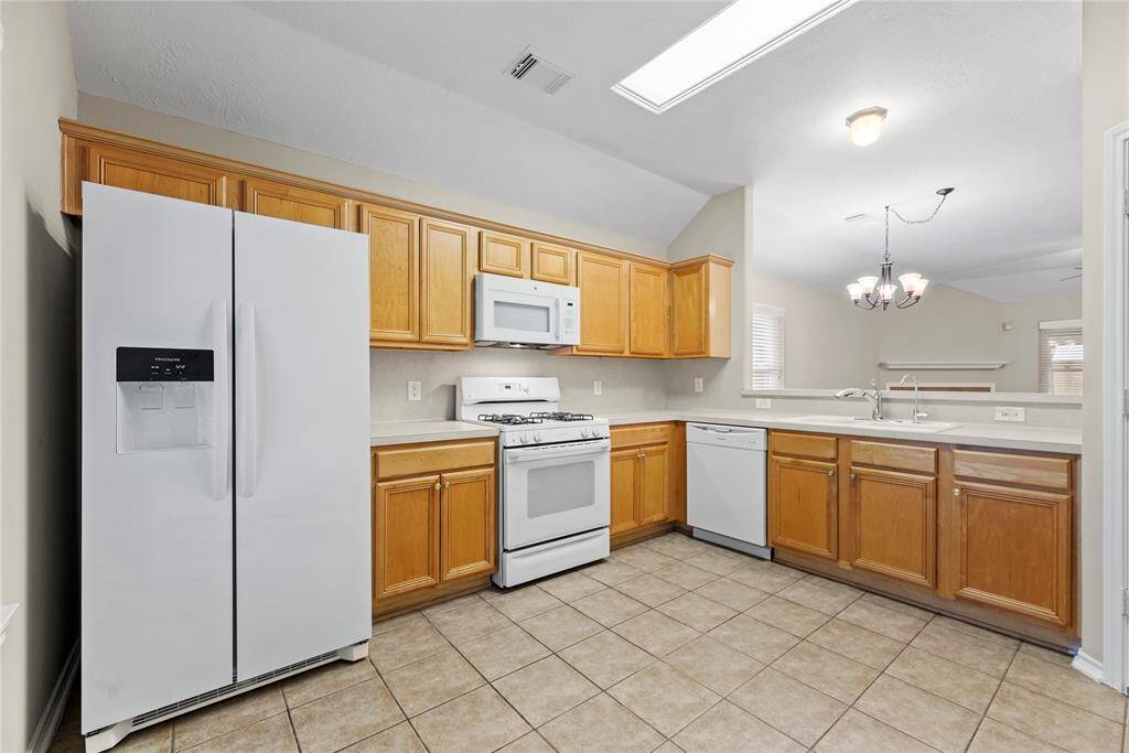 The open kitchen is beautiful, inviting, and functional.