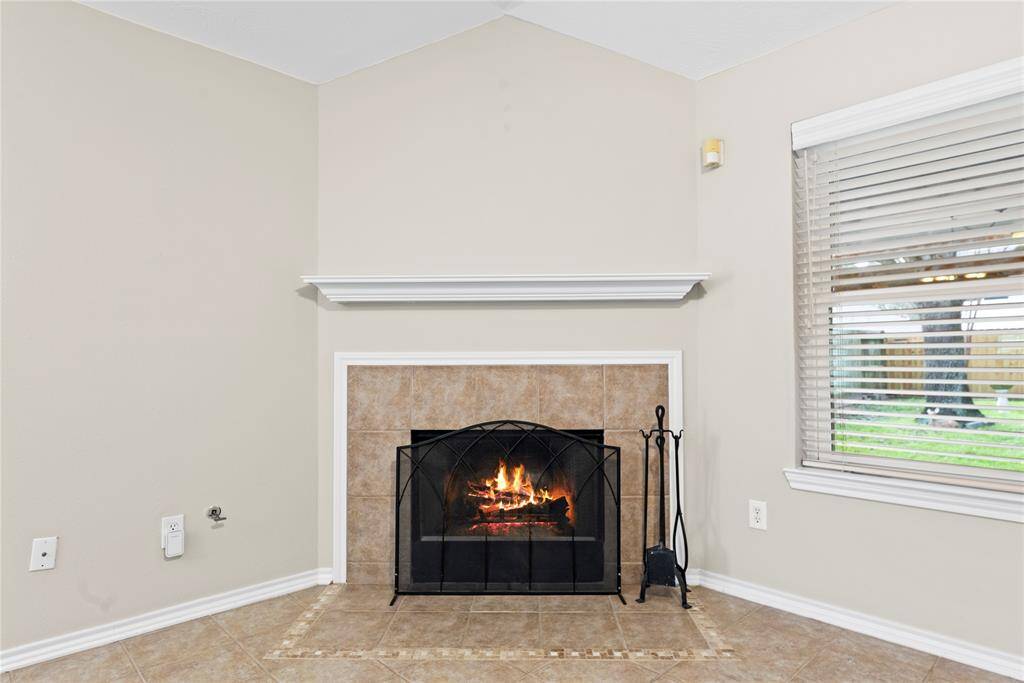 The inviting fireplace becomes a focal point that anchors the room and invites people to gather and linger, making it a cherished feature of the living area.
