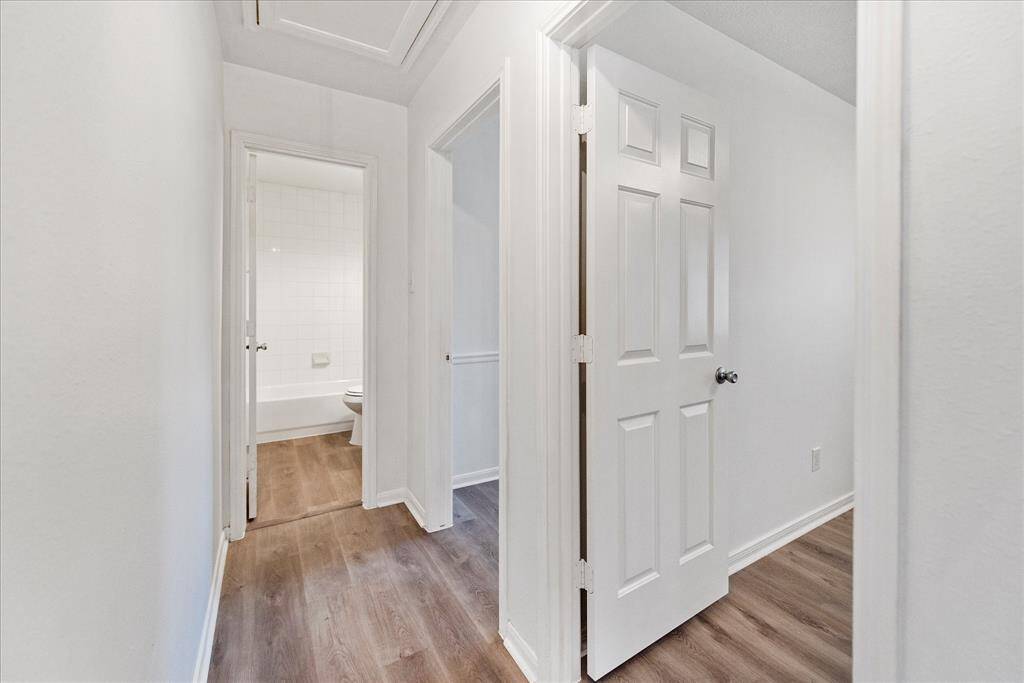 Hallway leads to secondary bedrooms and additional full bathroom.