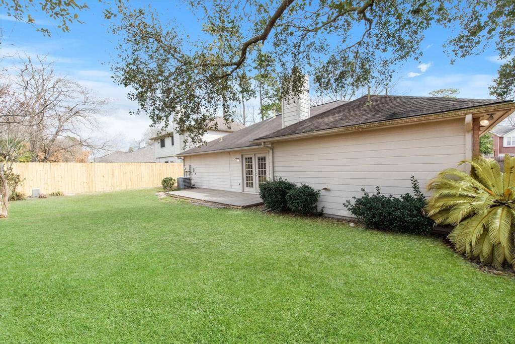 Huge backyard with fire pit, provides privacy with full deck and automatic sprinkler system.